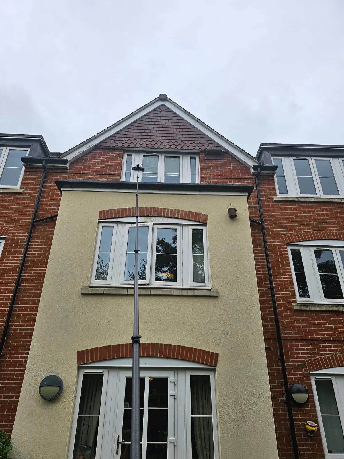 A tall brick building with a clock on the side of it.