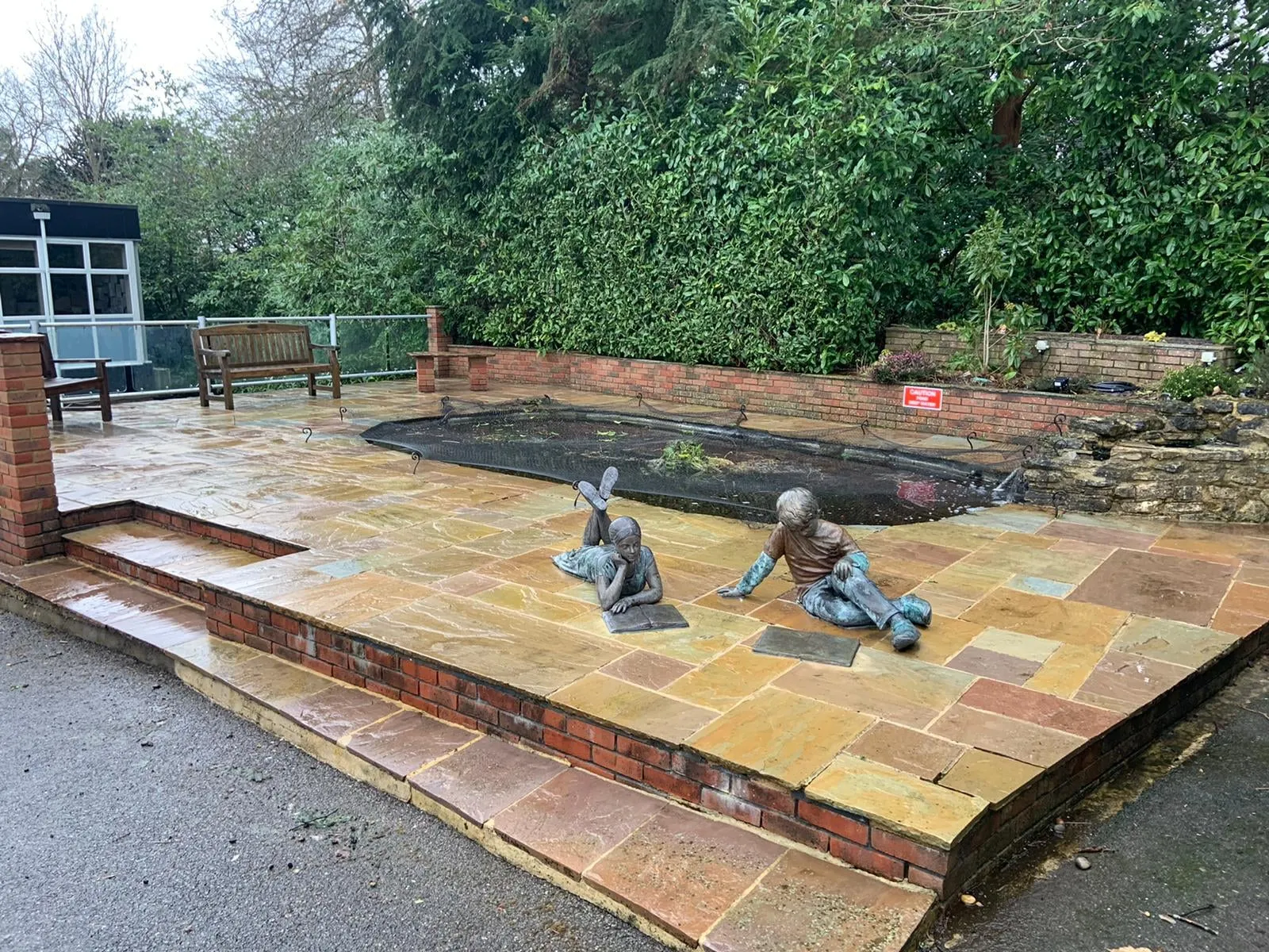 A couple of statues sitting on top of a wooden platform.